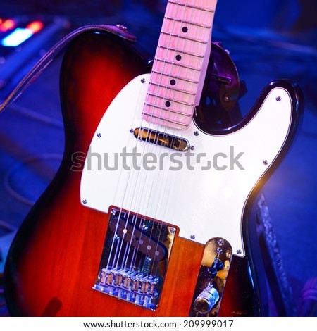 Electric guitar and other musical equipment on stage before conc