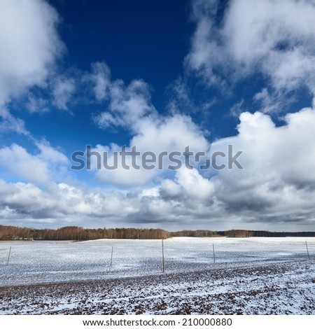 Heavy snow storm clouds over fields in countryside