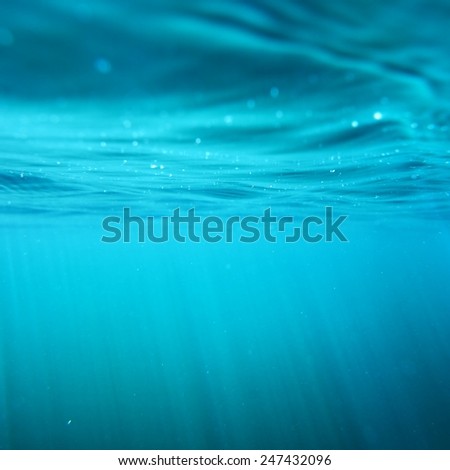 Underwater view with sun beams in turquoise water