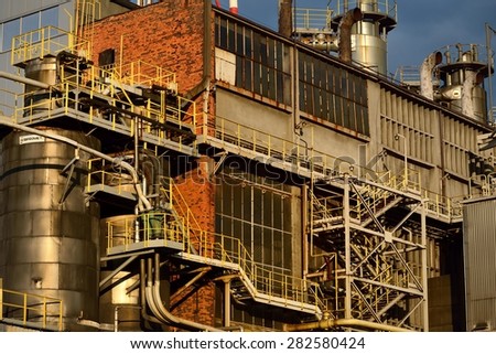 Industrial plant. Factory with pipes against blue sky