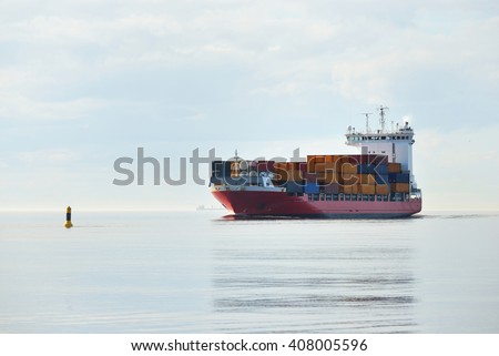 Large container ship sailing in still sea water