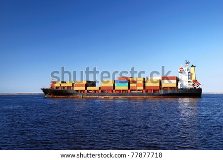 cargo ship sailing in still water