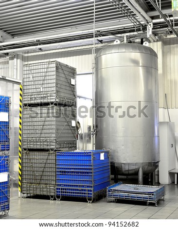 Large industrial tank and chemical containers at the clean warehouse