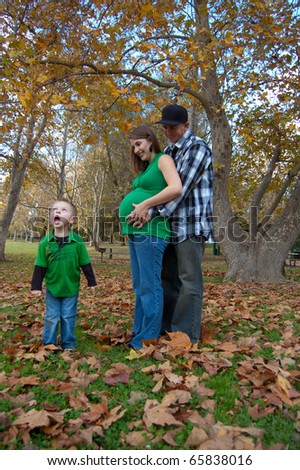 Attractive young family in park, boy singing