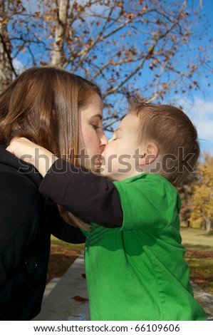 Young mom and son giving kiss
