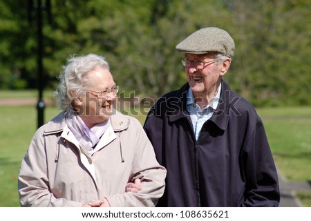 Happy senior couple walking in a park