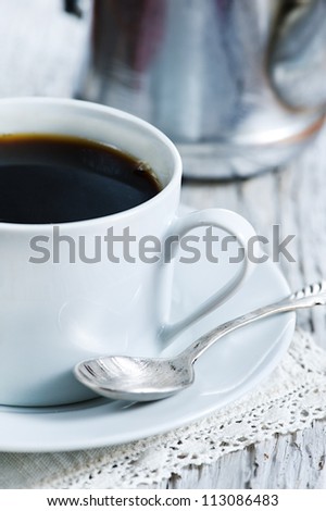 Cup of coffee and coffee pot
