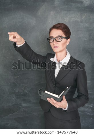 Woman teacher with organizer pointing on someone