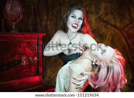 Beautiful vampire woman and her victim