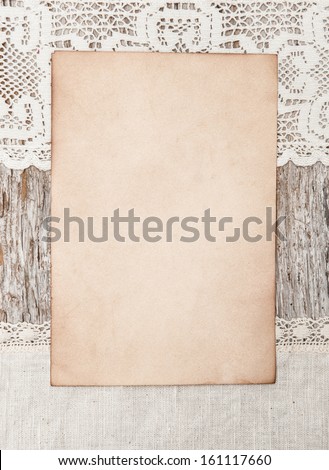 Aged paper and linen fabric on the old wood