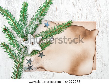 Christmas card with aged paper, stars and fir branches
