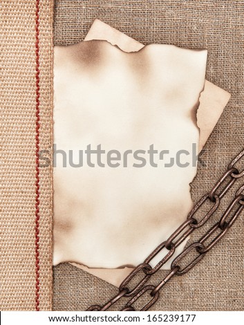 Aged paper with metal chain on sacking background