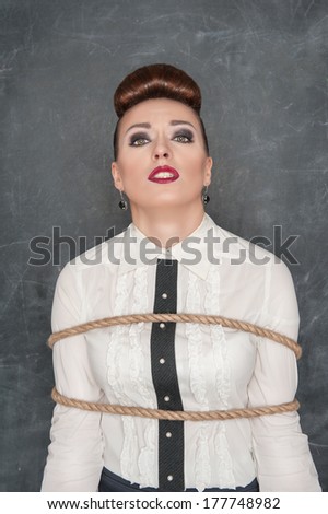 Business woman tied with rope
