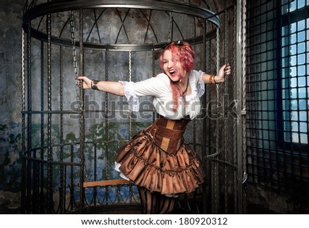 Screaming beautiful steampunk woman in the cage