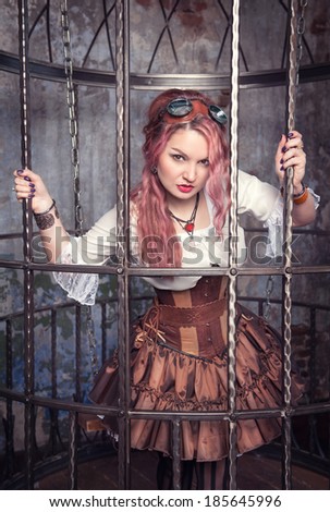 Beautiful steampunk woman in the cage