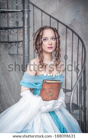 Beautiful woman in medieval dress with book