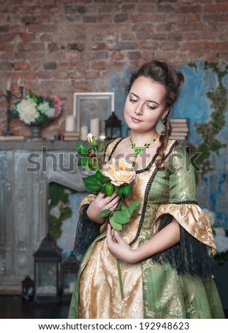 Beautiful woman in medieval dress with flower