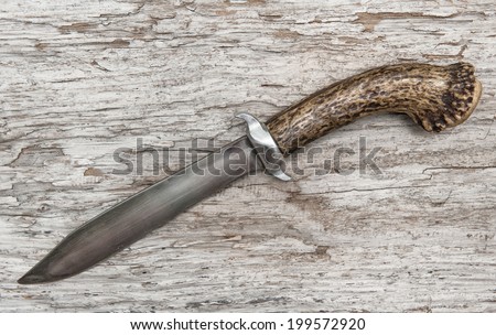 Old knife on the weathered wood