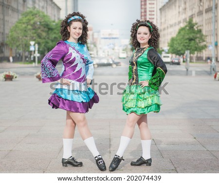 Two women in irish dance dresses outdoor