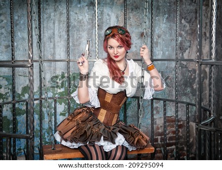 Beautiful steampunk woman in the cage with gun