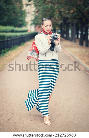 Beautiful woman with old retro camera