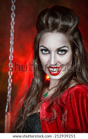 Beautiful halloween vampire woman with long tongue