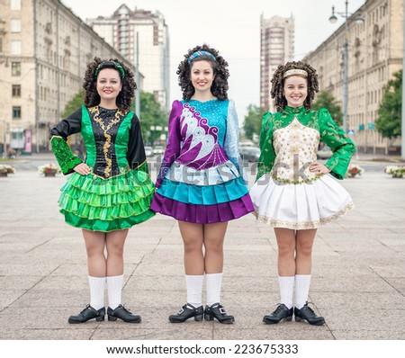 Three women in irish dance dresses posing