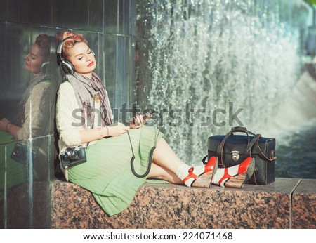 Hipster fashion girl listening music outdoor