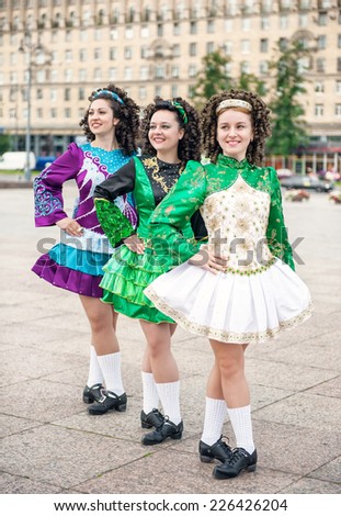 Three women in irish dance dresses posing outdoor
