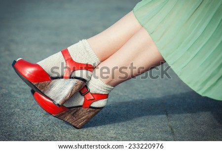 Legs of woman with high heels dressed green dress vintage style
