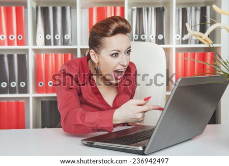 Angry screaming business woman working with computer