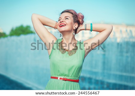 Happy beautiful young woman with braces  in vintage clothing outdoor