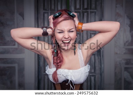 Beautiful steampunk woman in corset with pink hair screaming