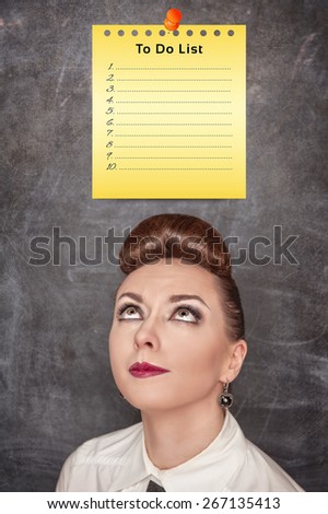 Concept of woman face looking on paper with to do list on the chalkboard background