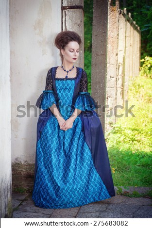 Beautiful young  woman in blue medieval dress outdoor