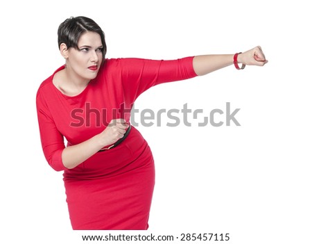 Beautiful plus size woman in red dress beating something isolated on white background