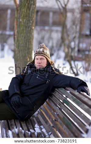Man on bench in winter