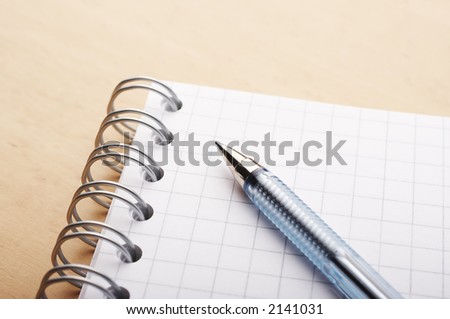 Blue ballpoint pen on the white cross-ruled paper