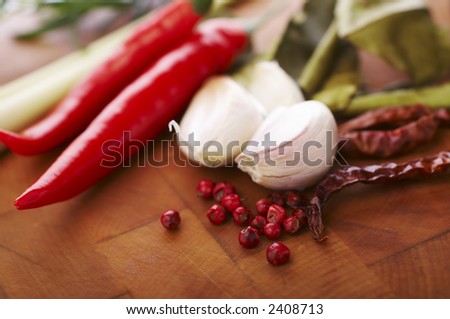 Thai food spices on wooden board (pepper, chili, garlic and lemon grass)
