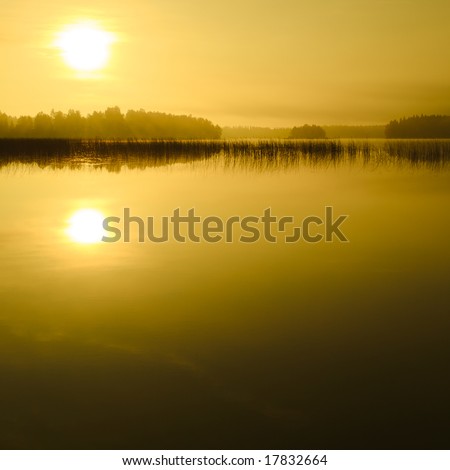 Sunrise at the lake in eastern part of Finland (golden version)