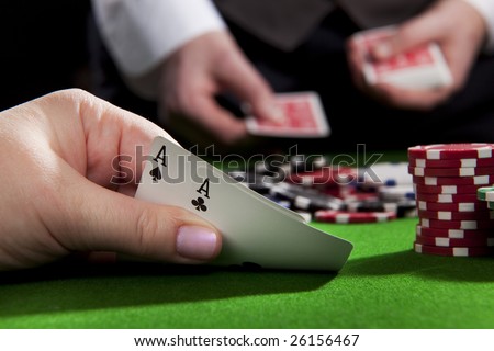 stock photo : Playing poker in the casino with winning hand (ace pair
