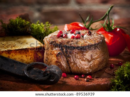 Grilled bbq steak with potato cube and tomatoes.