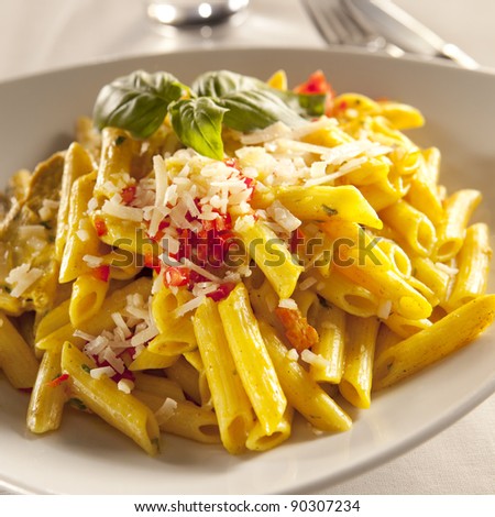 Yellow chicken pasta with parmesan cheese and chili pyree