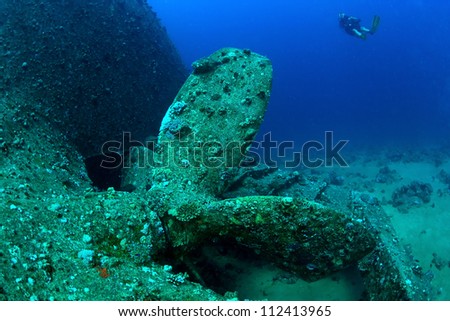 Big screw propeller of Ship wreck Chrisula K and diver, Red Sea, Egypt.