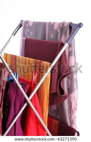 colorful clothes hanged for drying after laundry clothes airer, clothes dryer isolated on white