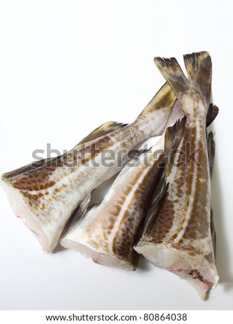 Raw cod fish fillets in kitchen on white background