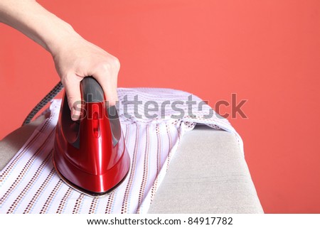 household chores - red iron in hand and white shirt