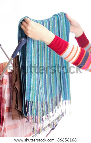 colorful clothes hanged for drying after laundry clothes airer, clothes dryer isolated on white and woman hand