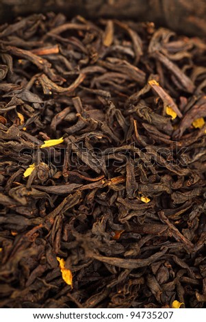 black Tea background, texture dry leaves, tea scented with bergamot oil Macro background