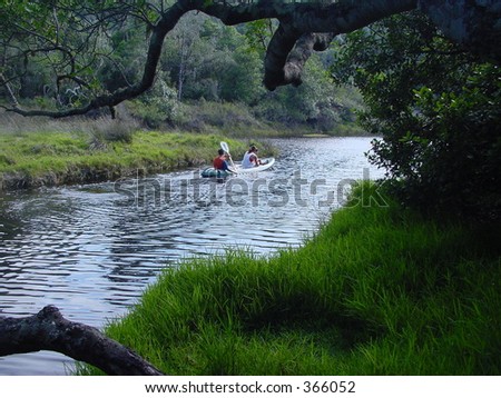 A couple rowing on the waters of a river in Natures Valley, South Africa